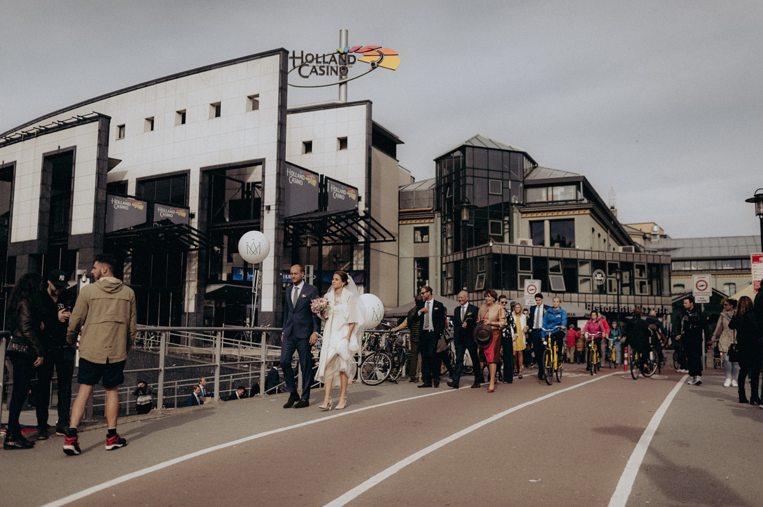 Wedding guests walking the streets of Amsterdam