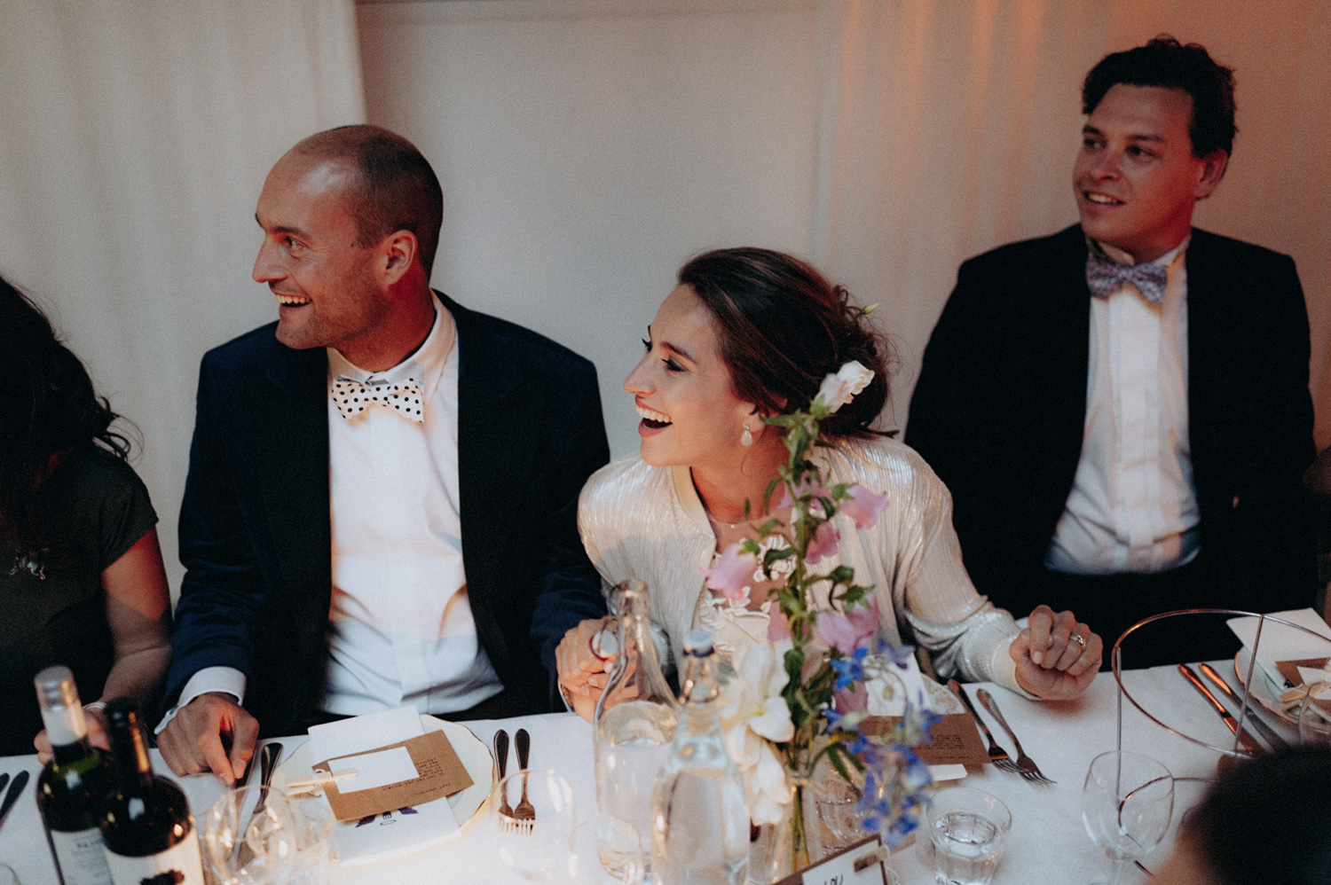 Bride and groom laughing while dining at Rijk van de Keizer