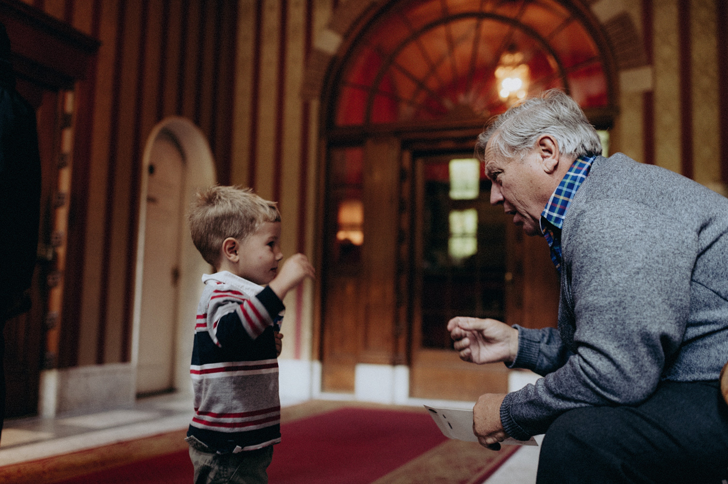 Kid playing jokes with his grandad