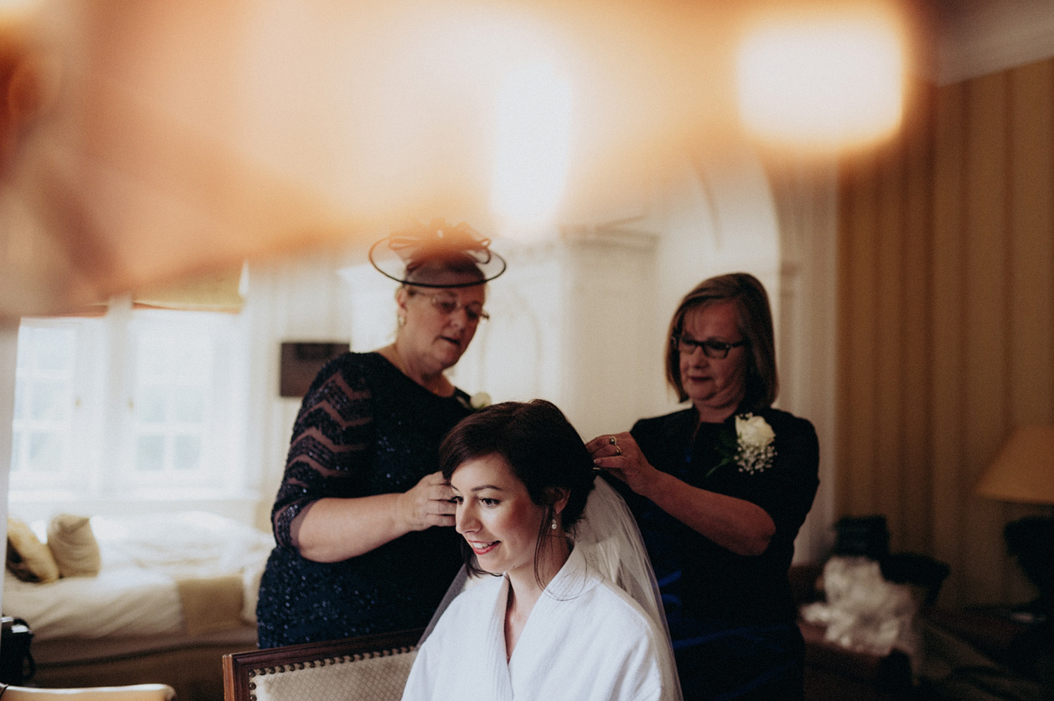 Bride getting her veil done by mother