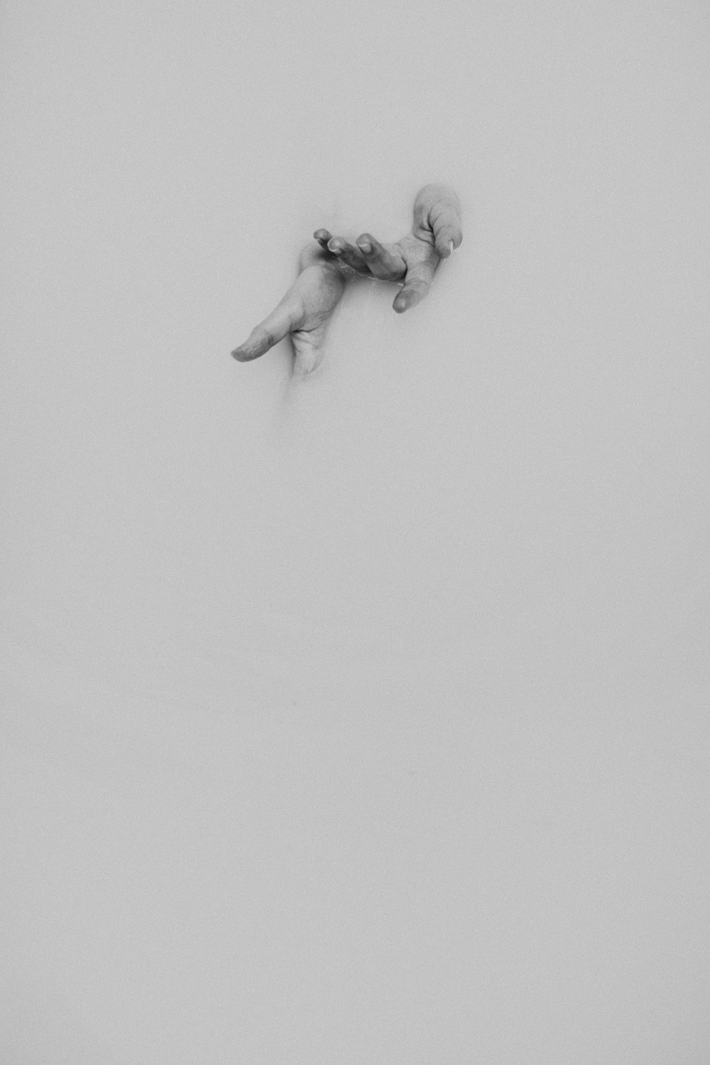 hands in bathtub filled with milk