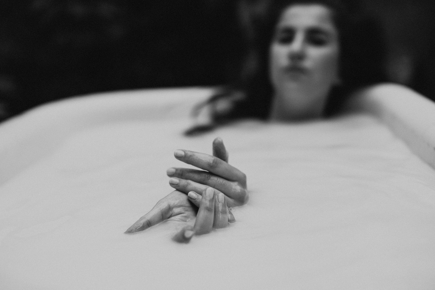 hands in bathtub with milk