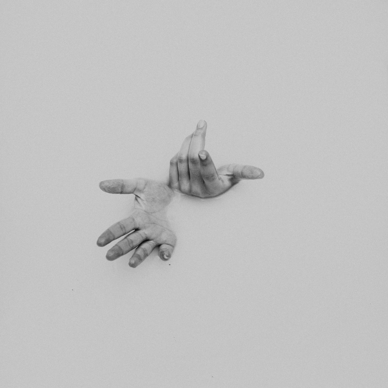 hands in bathtub filled with milk