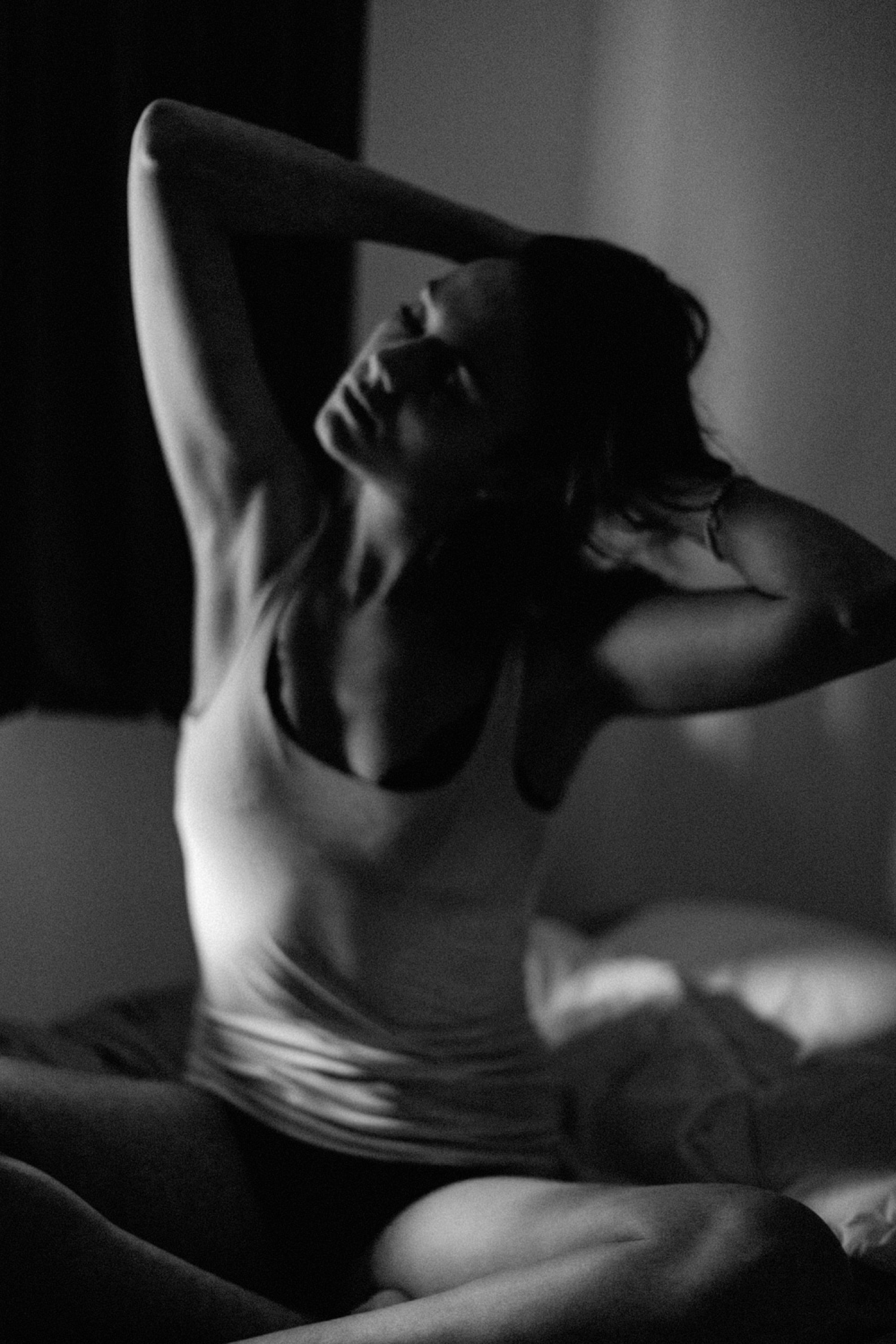 Boudoir shot with girl sitting on bed