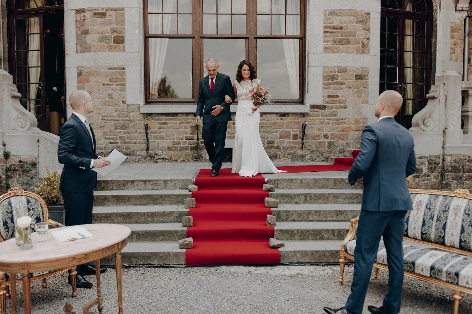 Bride arriving at ceremony in Chateau de Presseux