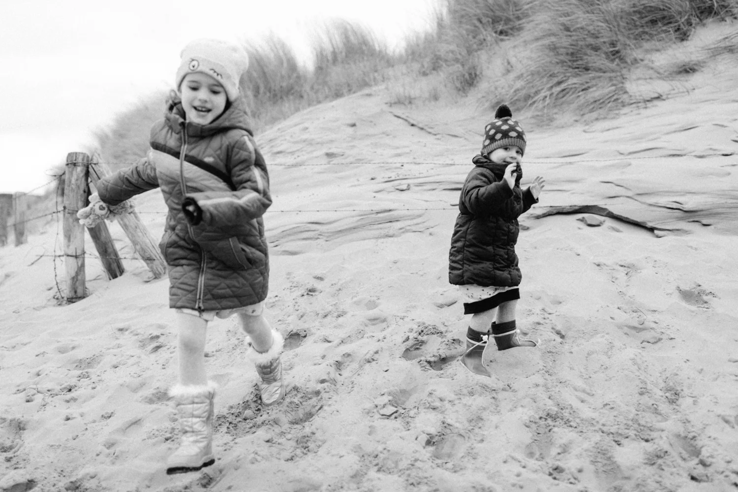 Sisters running and playing at the beach