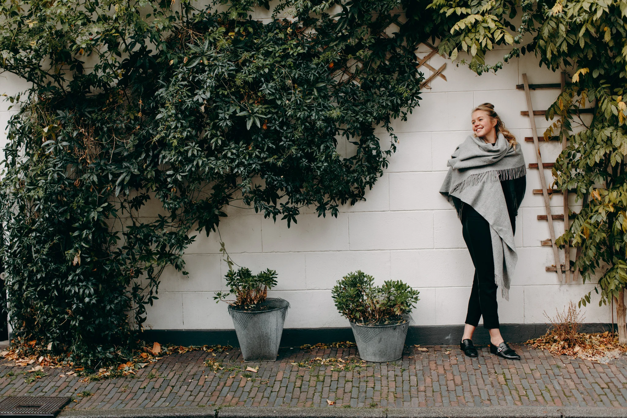 Portrait of Marieke in front of wall with plants