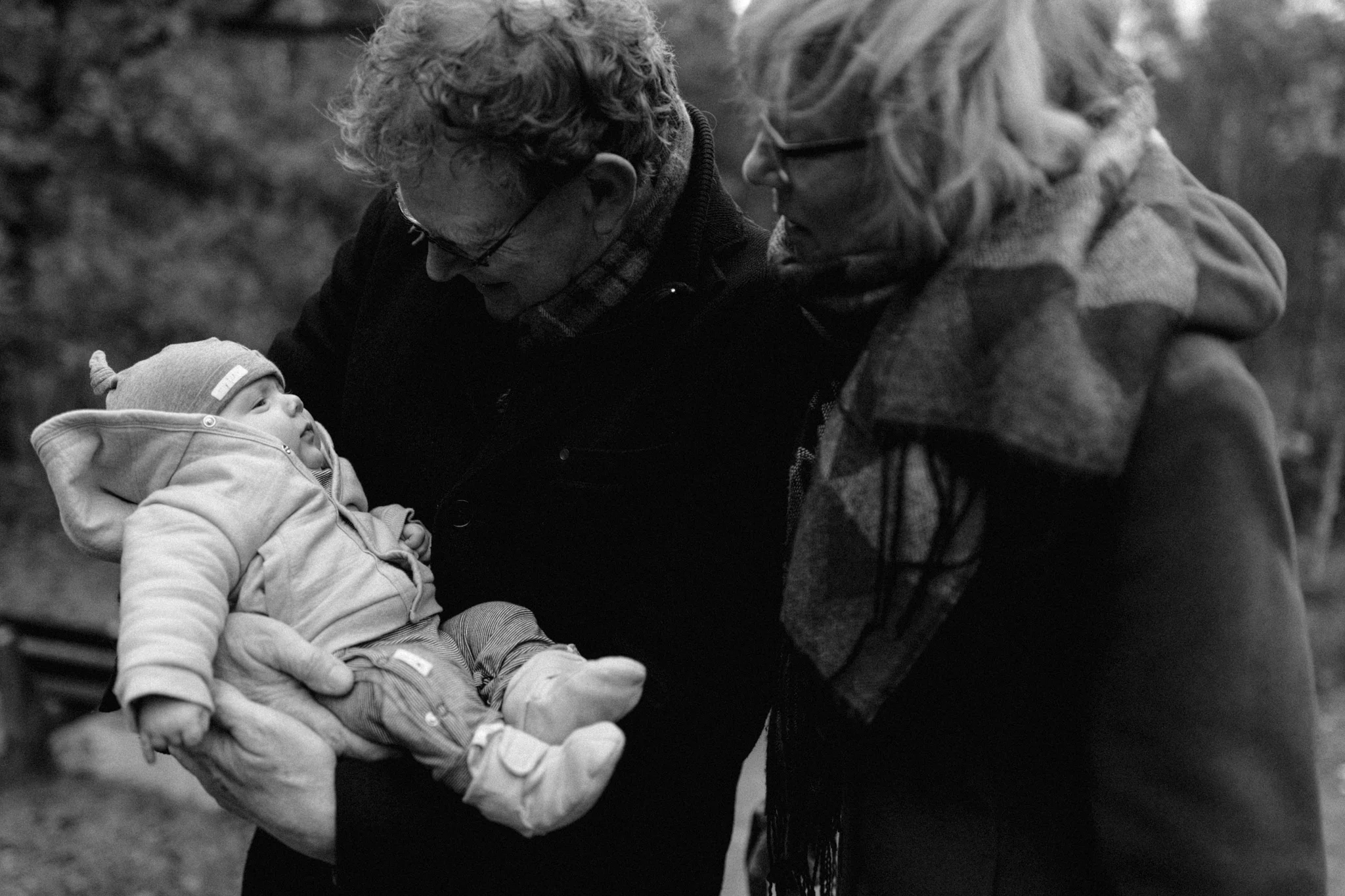 Grandfather and grandmother holding baby