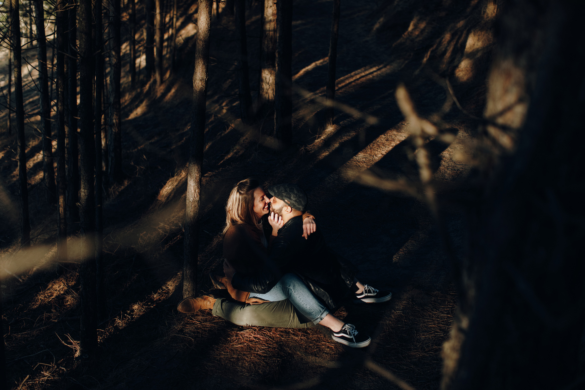 Couple sitting in sunbeam in the forrest