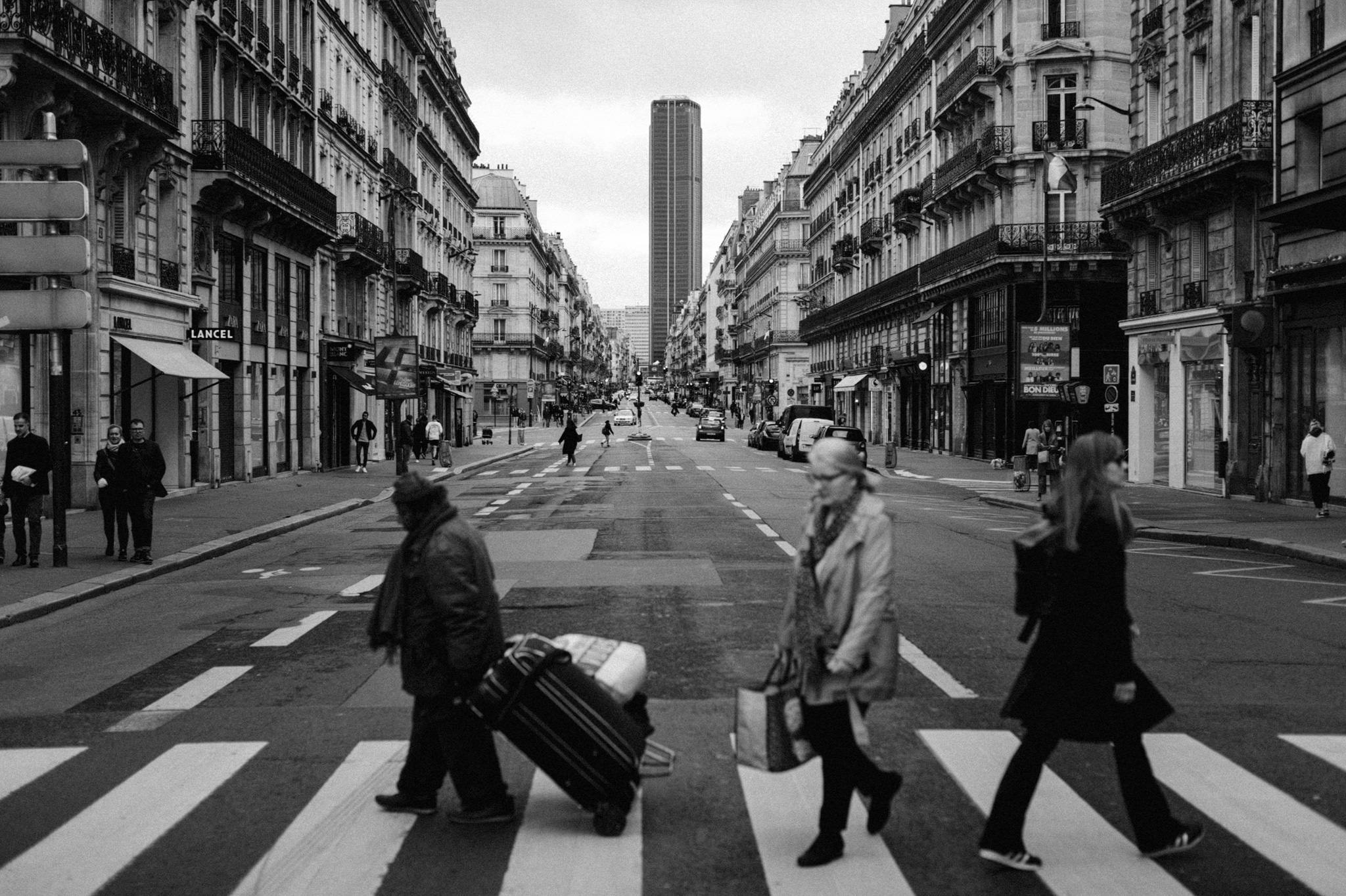 People crossing street on crossover in Paris, France