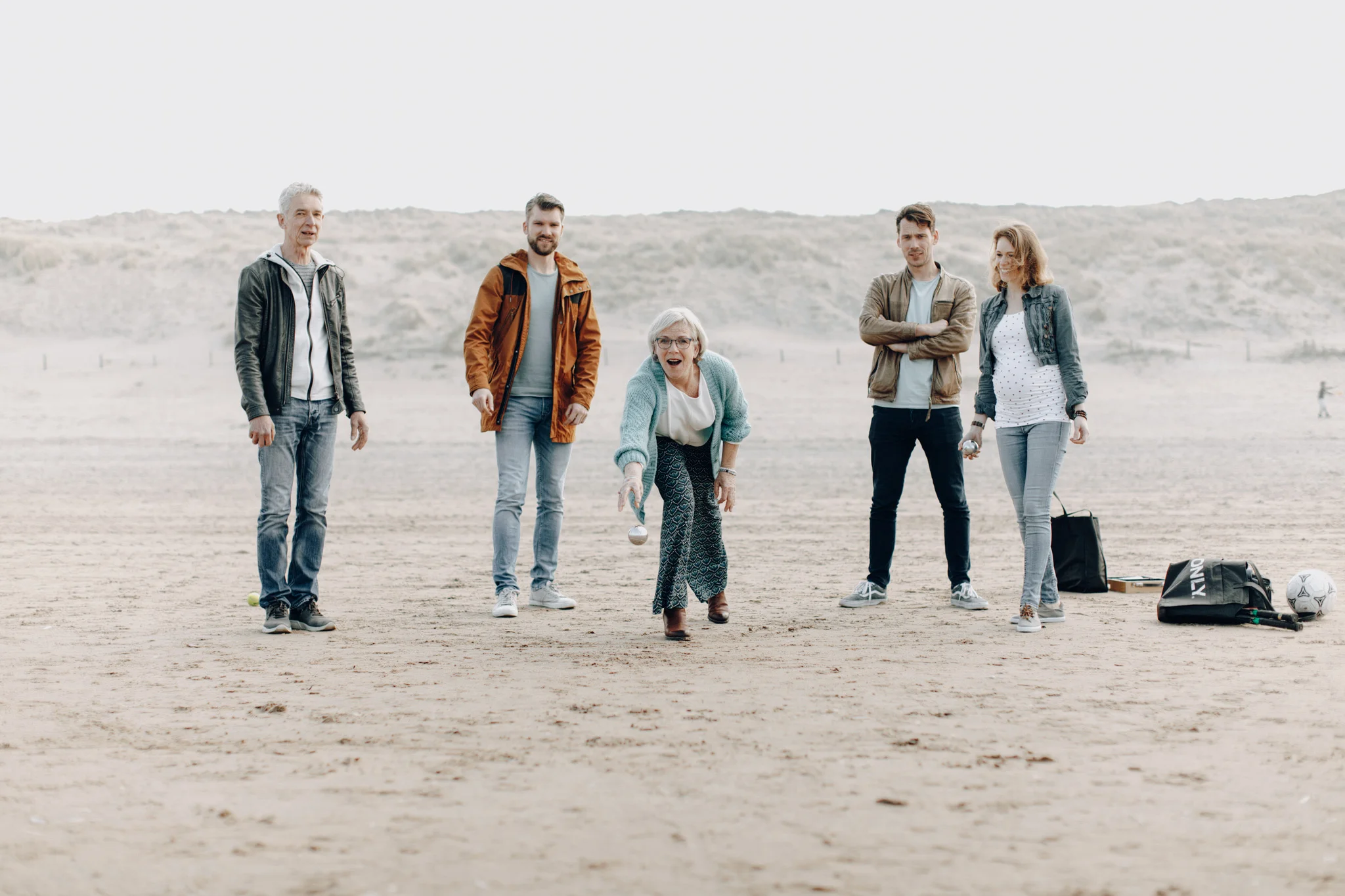 Family playing jeu de boules at the beach