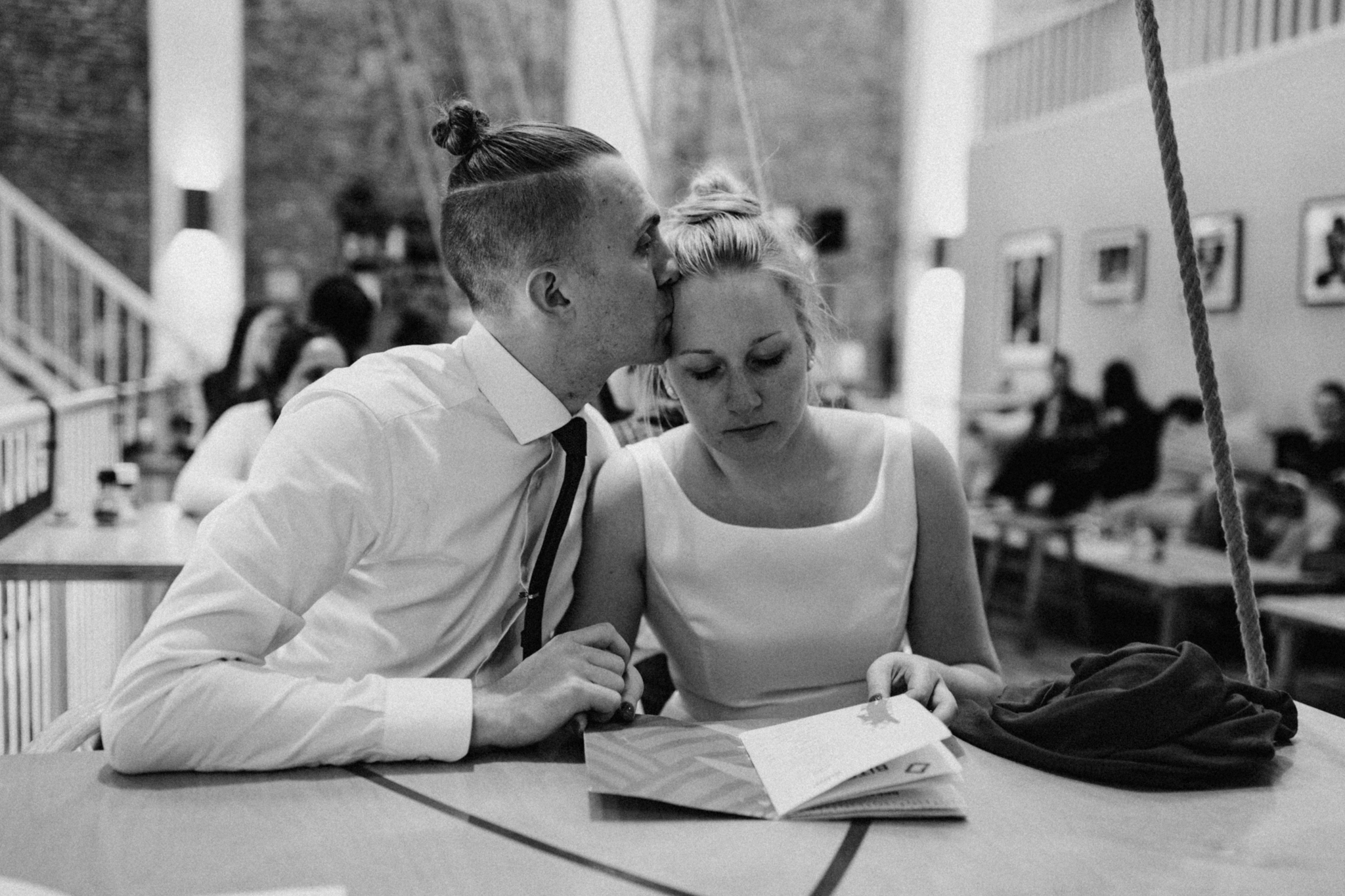 Groom kissing his bride on the head