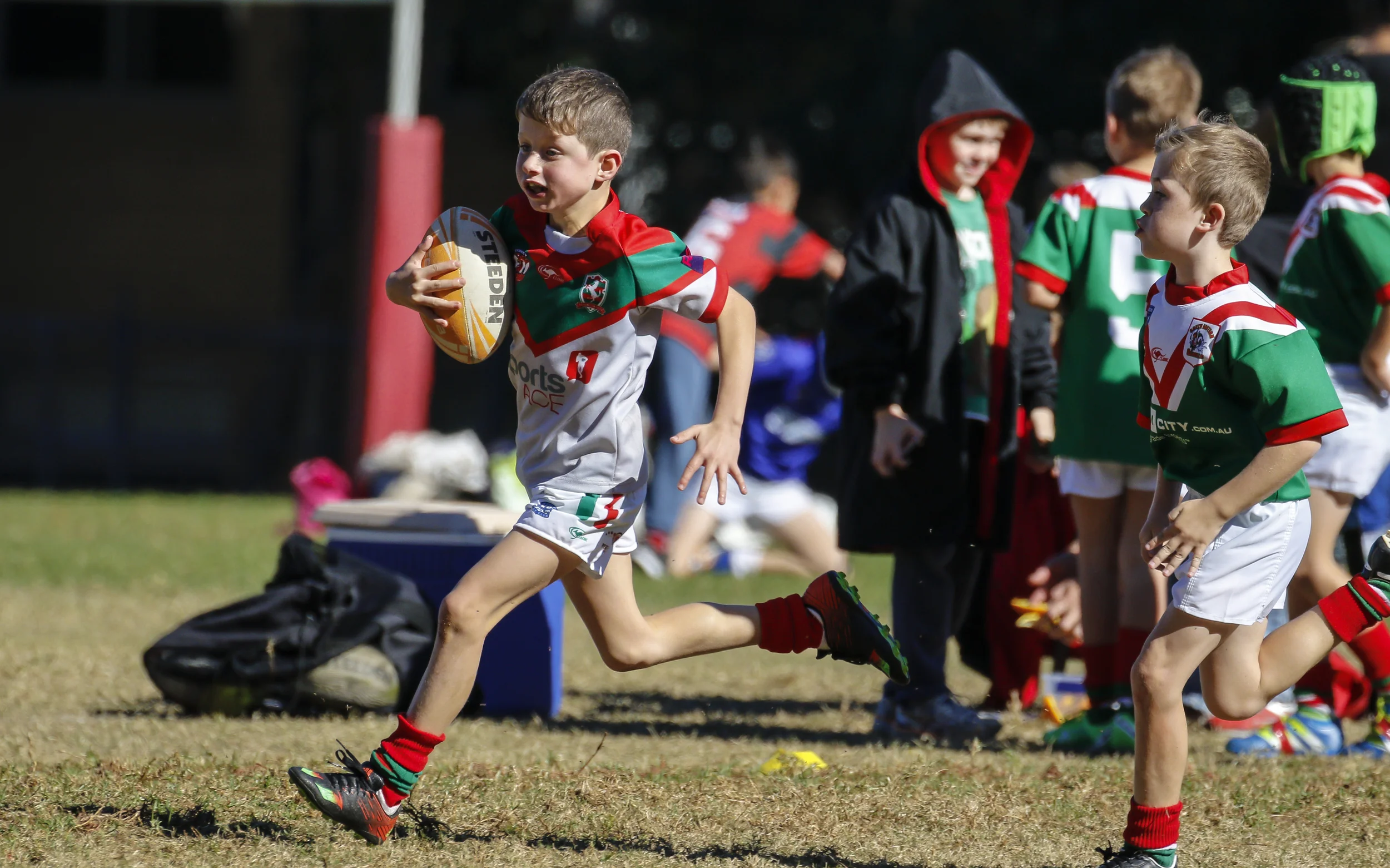 Angus Peshos makes a break in the under 8's game win over South Eastern