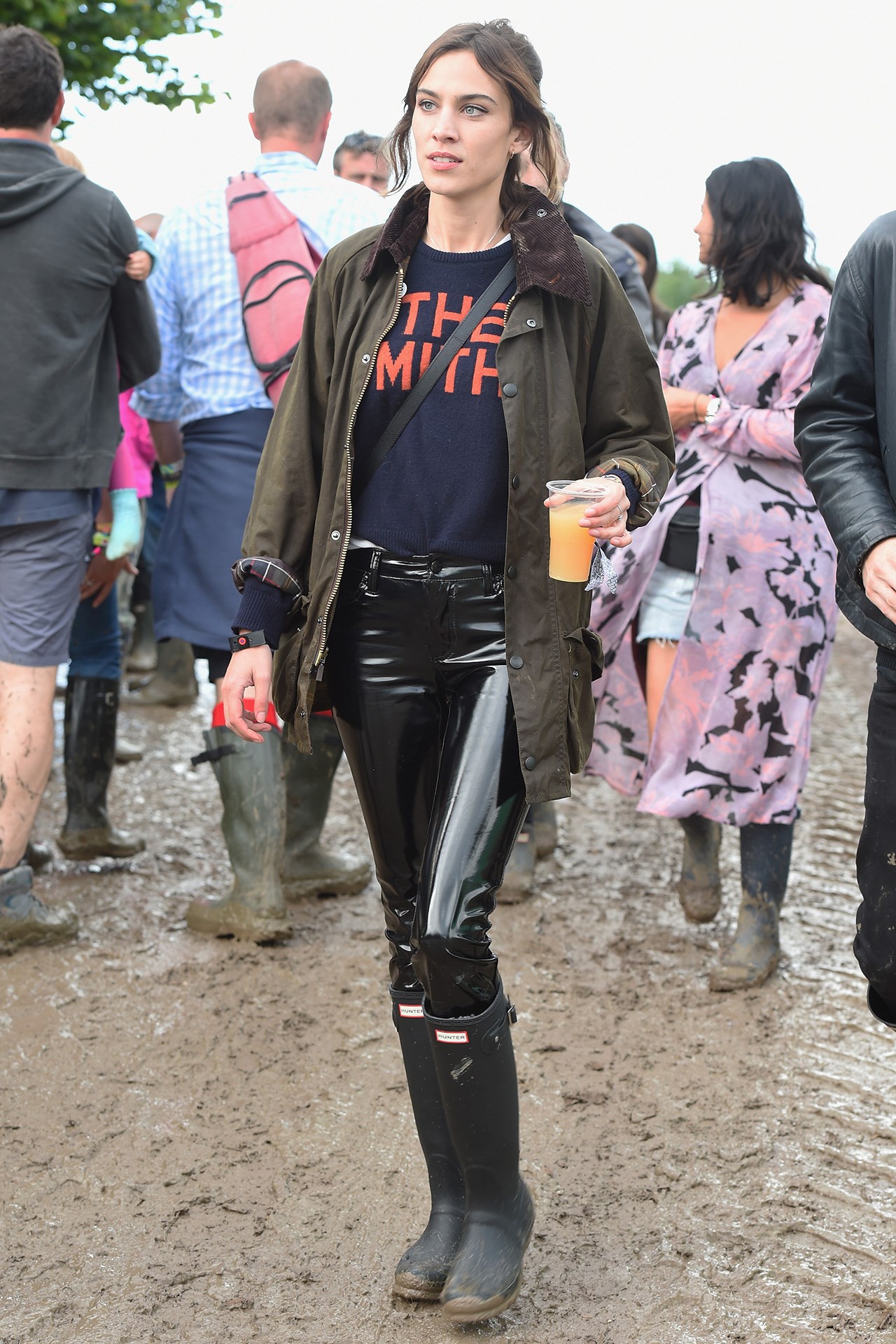 Alexa Chung wearing the token Smiths sweater with some insane Vinyl pants and of course a Glastonbury necessity: Hunter Boots