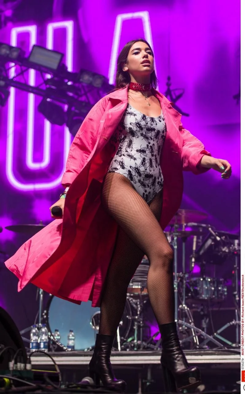 My actual dream queen Dua Lipa wearing a sick bodysuit paired with probably the coolest pink coat and OF COURSE! Fishnets (did she read my trends post on them?)