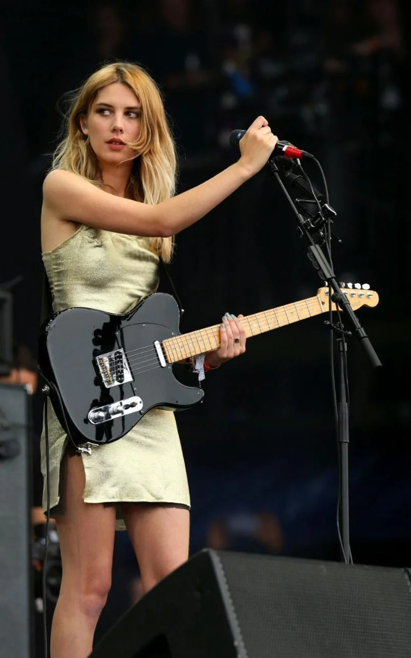 Ellie Rowsell of Wolf Alice wearing a KILLER golden dress