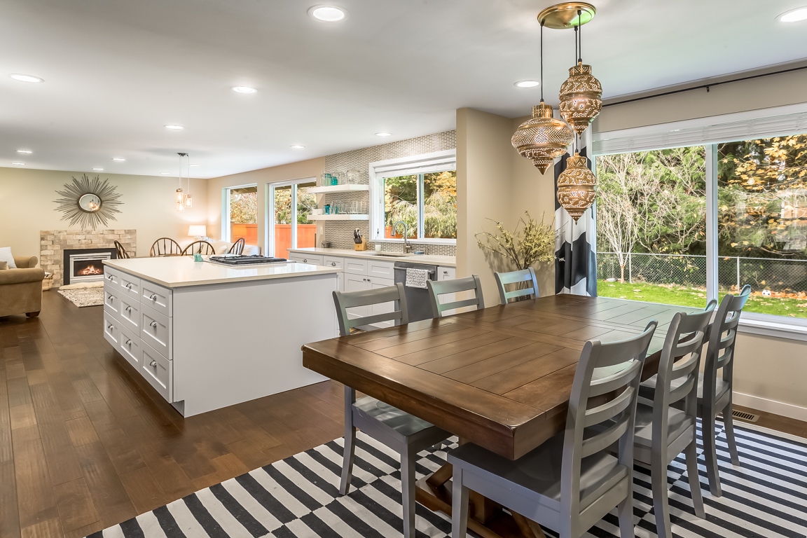 Another view of the kitchen from the dining room. Adding a double-sided island increased storage space and a downdraft range makes for an open feel in the kitchen (no range hood necessary)!