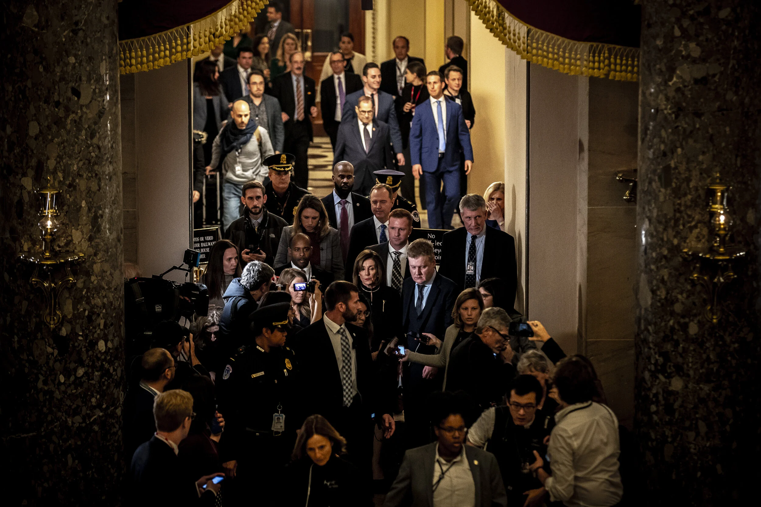  House Speak­er Nancy Pelos­i, D-Calif., is swarmed by reporters after the U.S. House of Representatives voted to impeach President Donald Trump in Washington, D.C., on Wednesday, Dec. 18, 2019. 