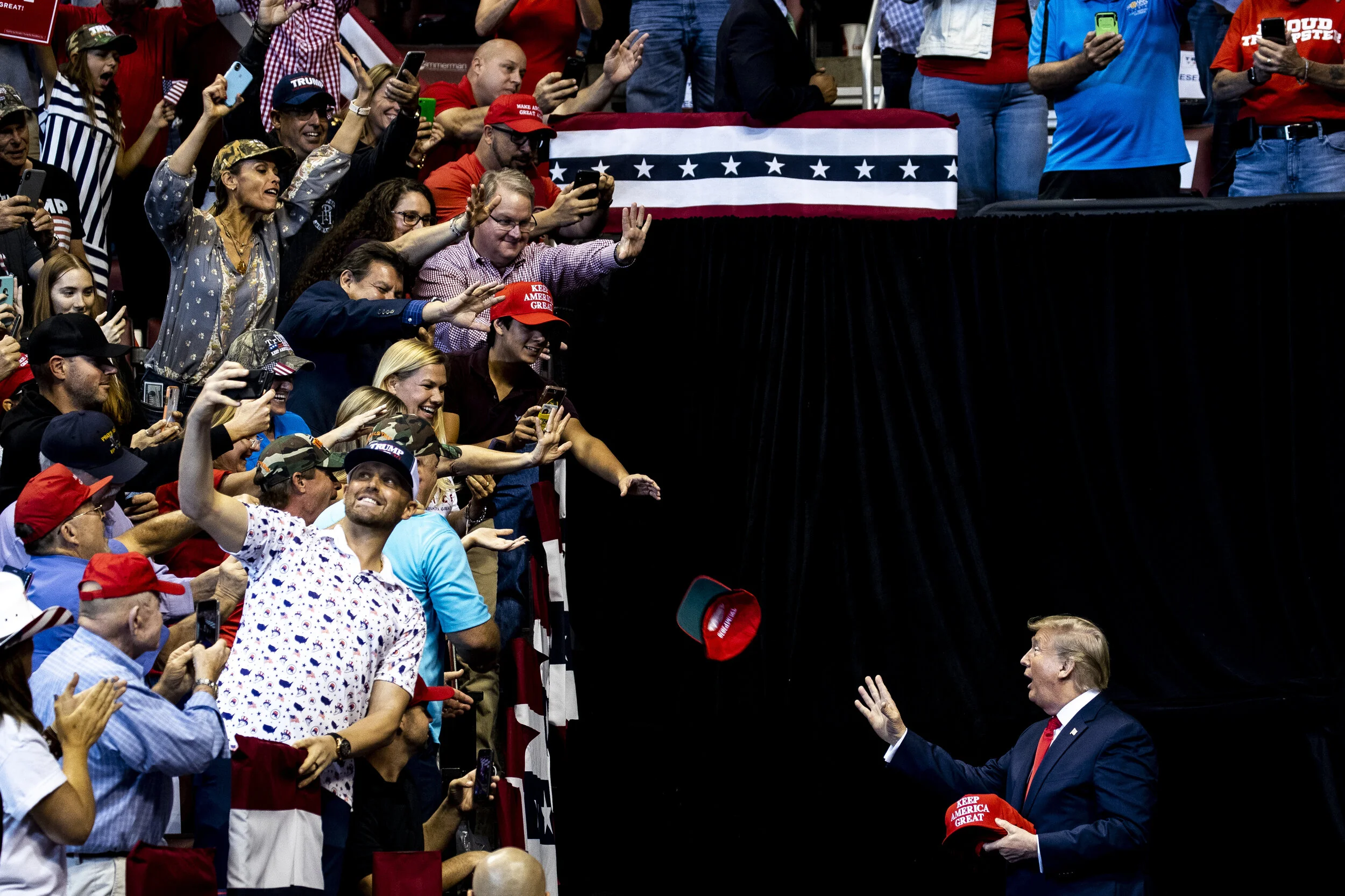  President Donald Trump throws a hat to supporters at a "Keep America Great Rally" at the BB&amp;T Center in Sunrise, Florida on November 26th, 2019. 