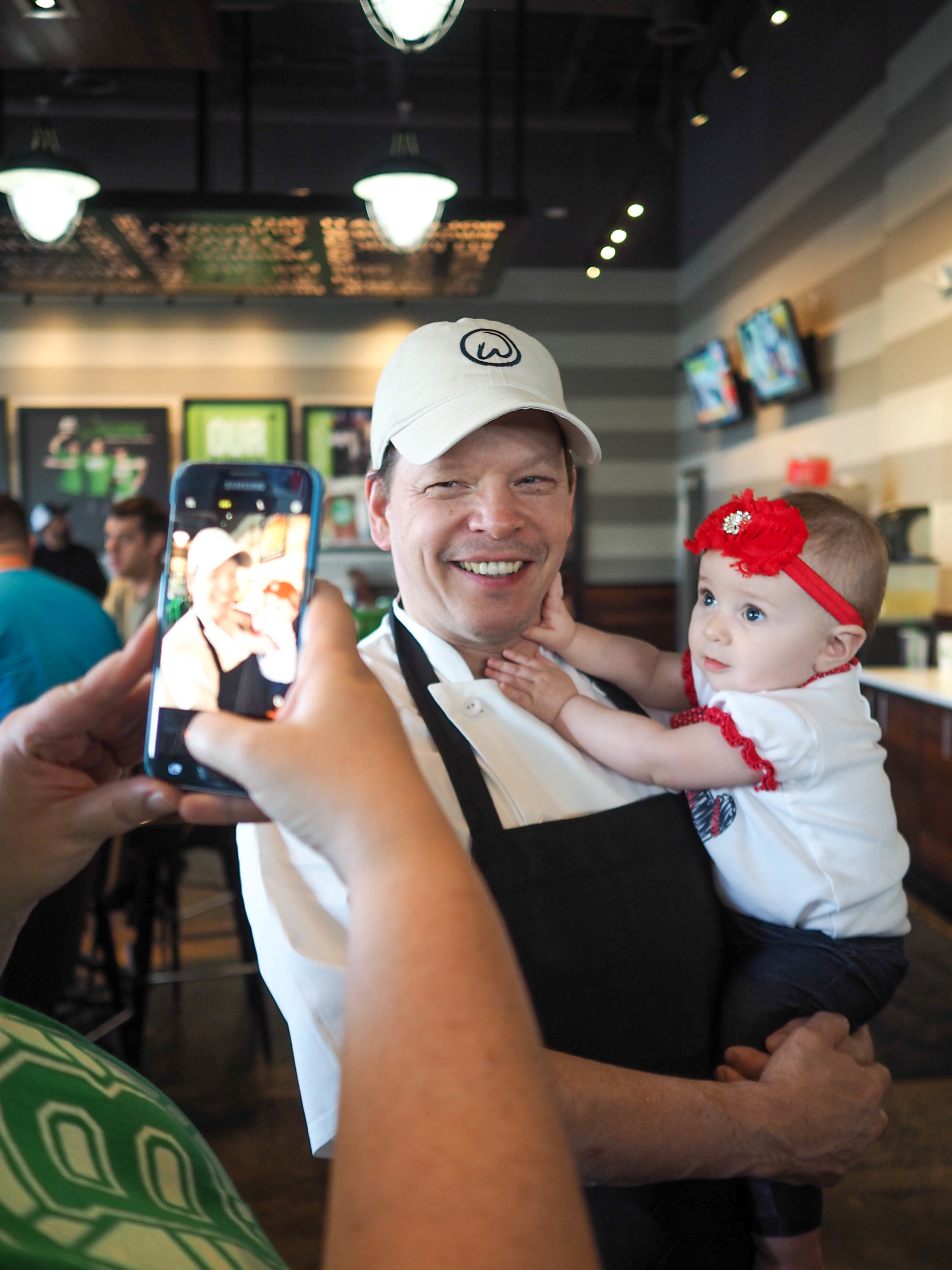 Executive Chef Paul Wahlburg poses with baby