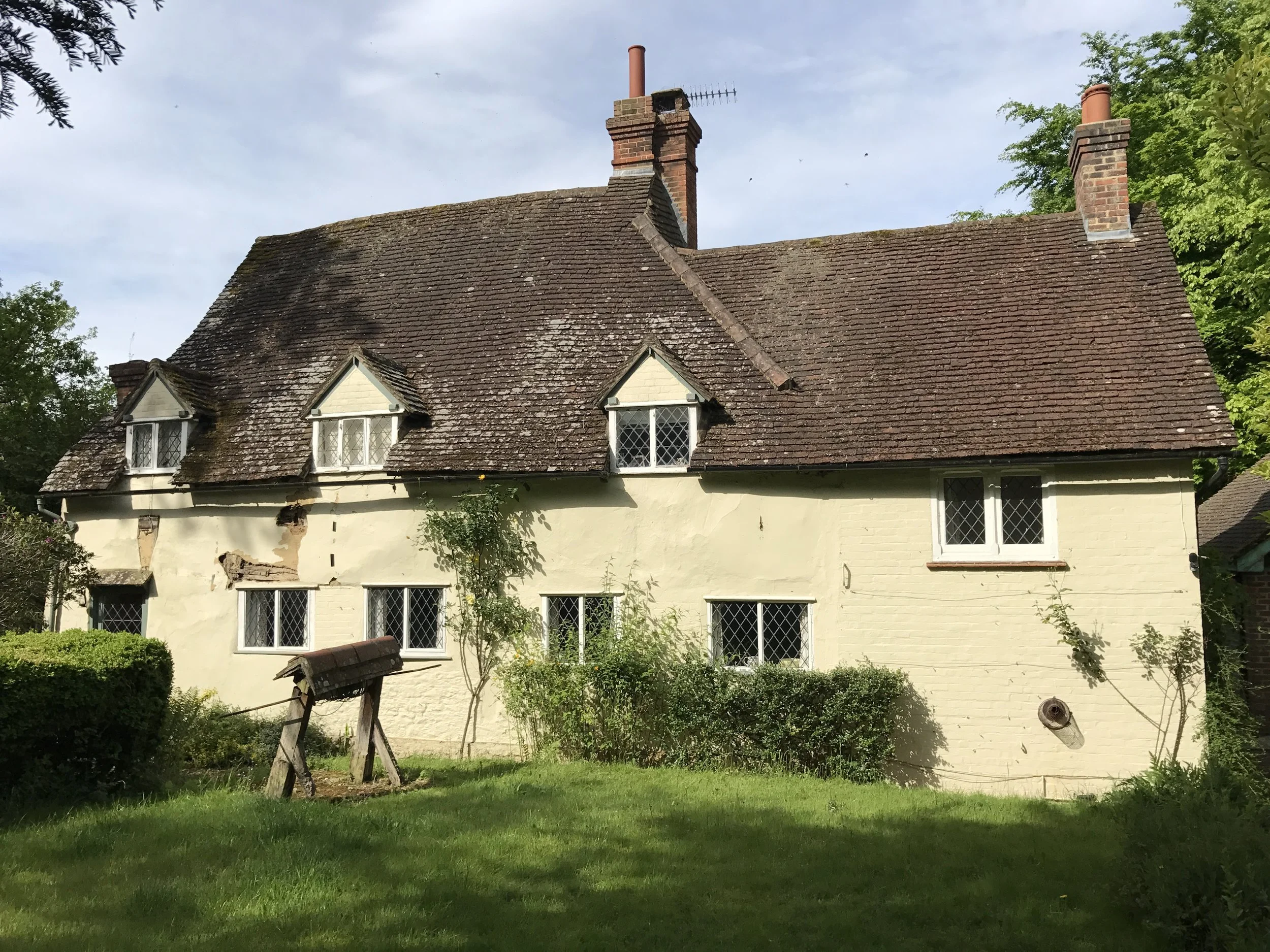 This image shows Old Well Cottage before work started. the initial concern was cracking and loose cementitious render which was allowing water penetration.
