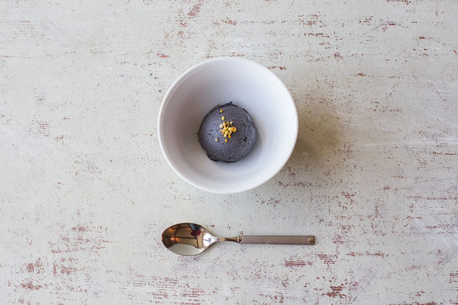 Raw plant-based black sesame ice cream with bee pollen and acai