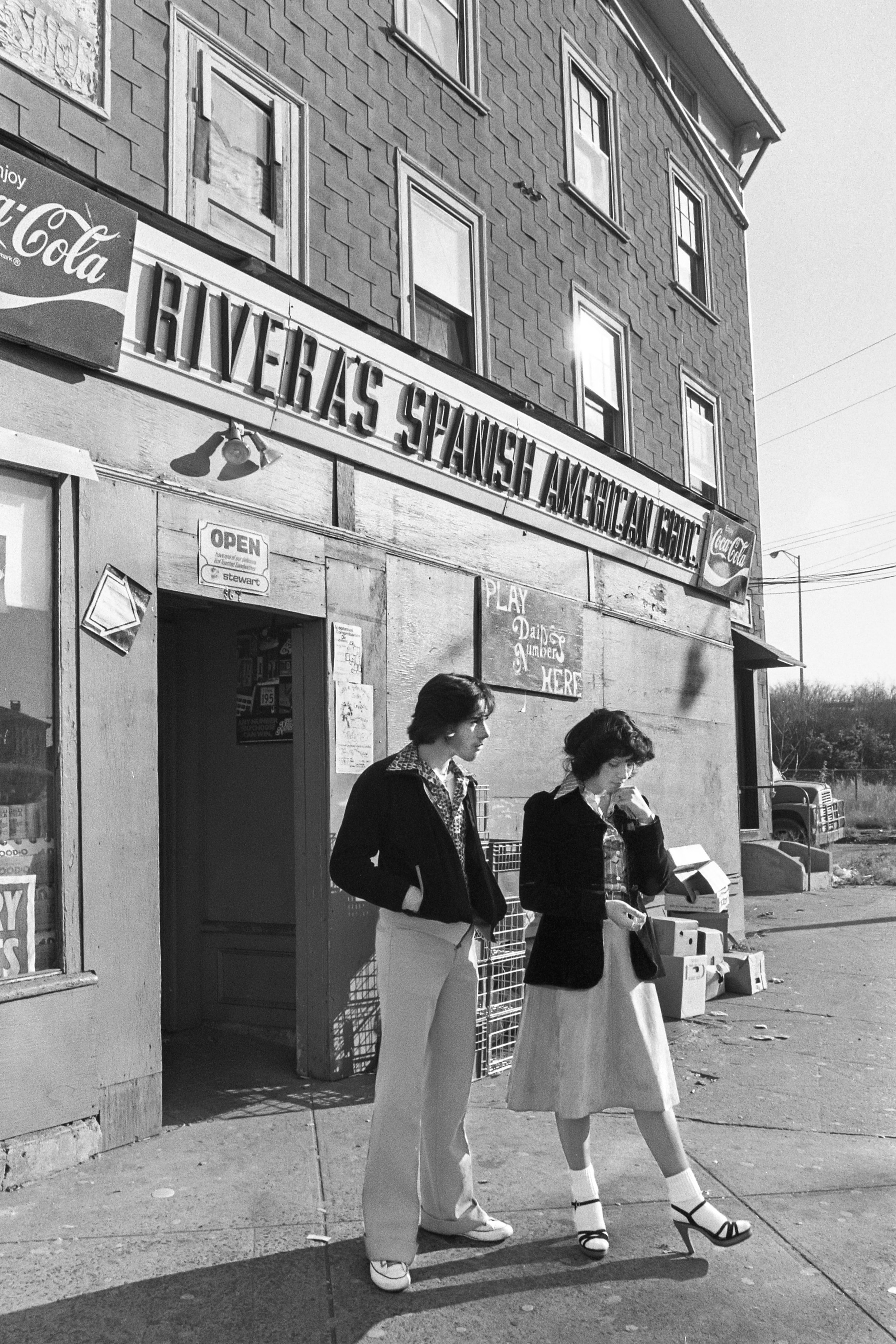  Young couple visiting outside of Rivera’s Spanish American Grocery in 1978. Today, this is the site of Marjolaine Pastry Shop. 