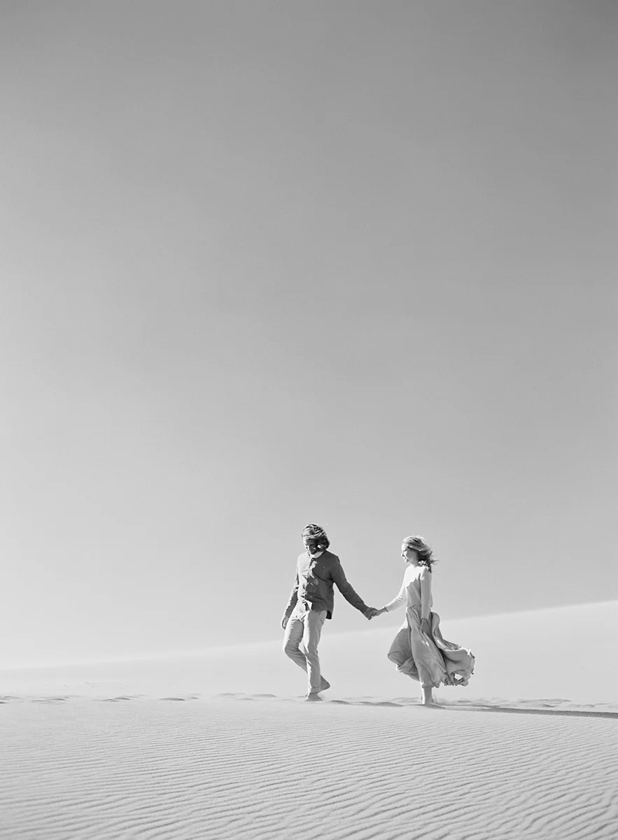 windy sand dunes engagement session