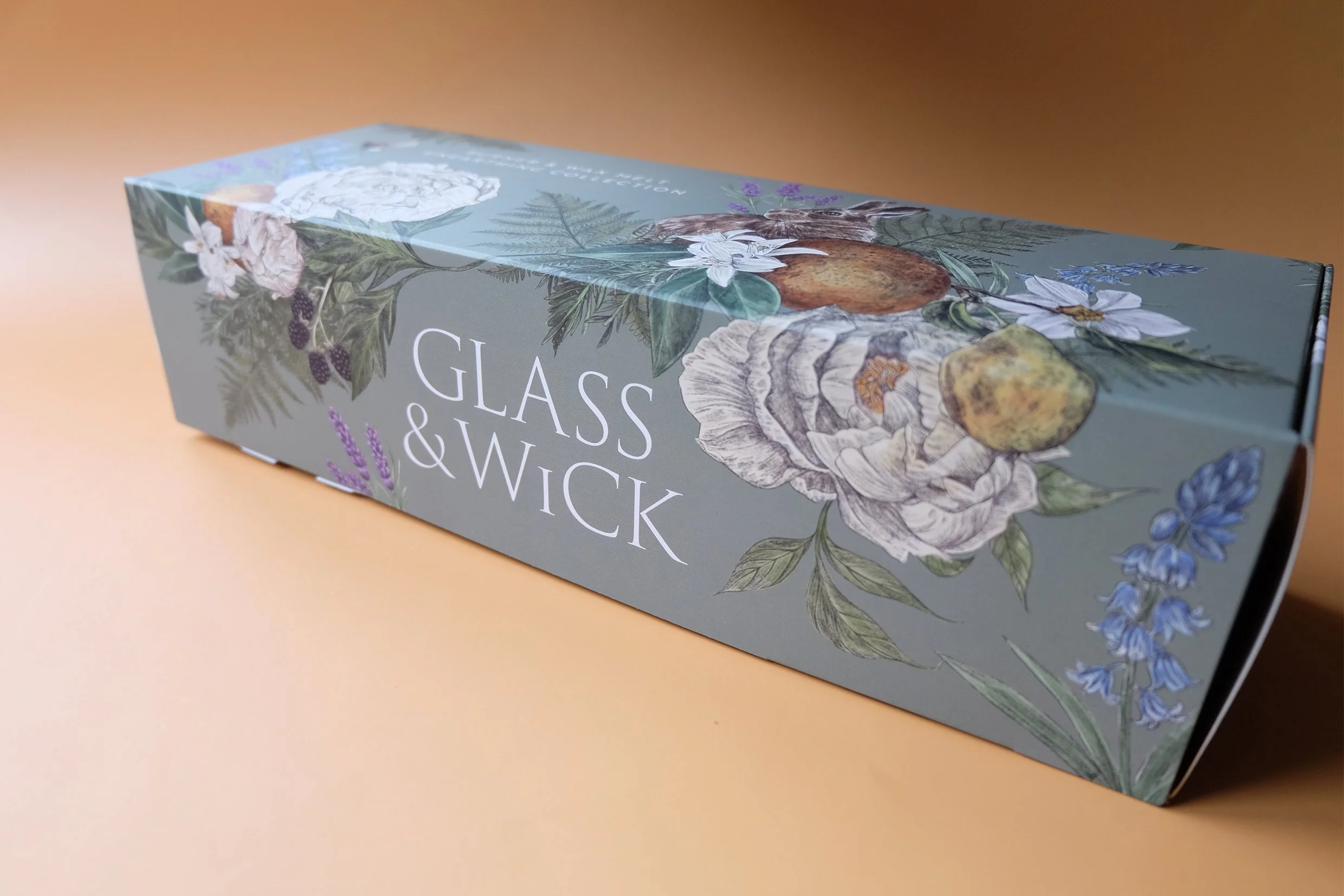 Front view of the Glass & Wick Burner and wax melt unearthing collection gift box illustration