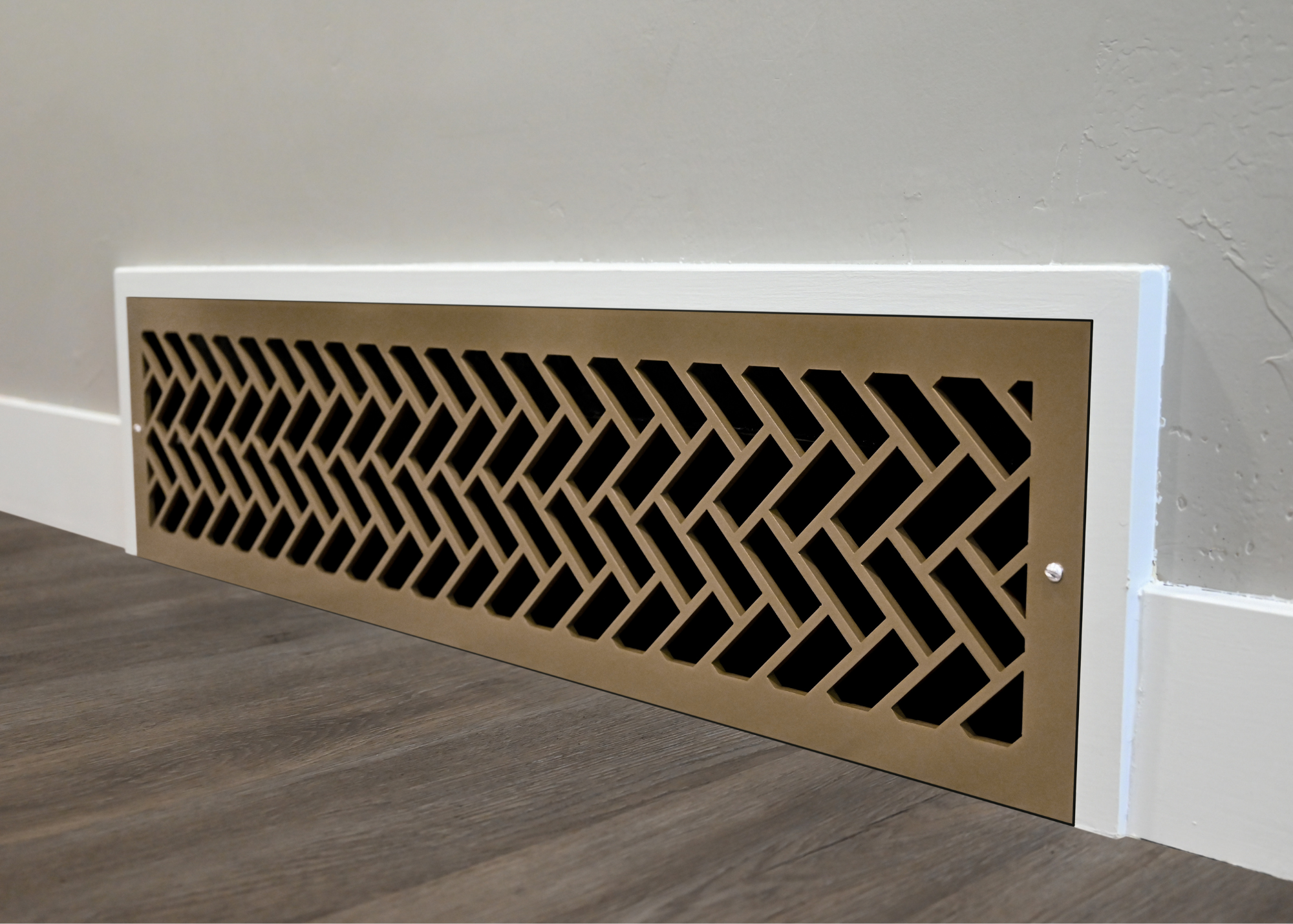 Oversized decorative steel register located on the wall. This beautiful metal grill is cut in the herringbone pattern and powder coated in the vintage gold. 
