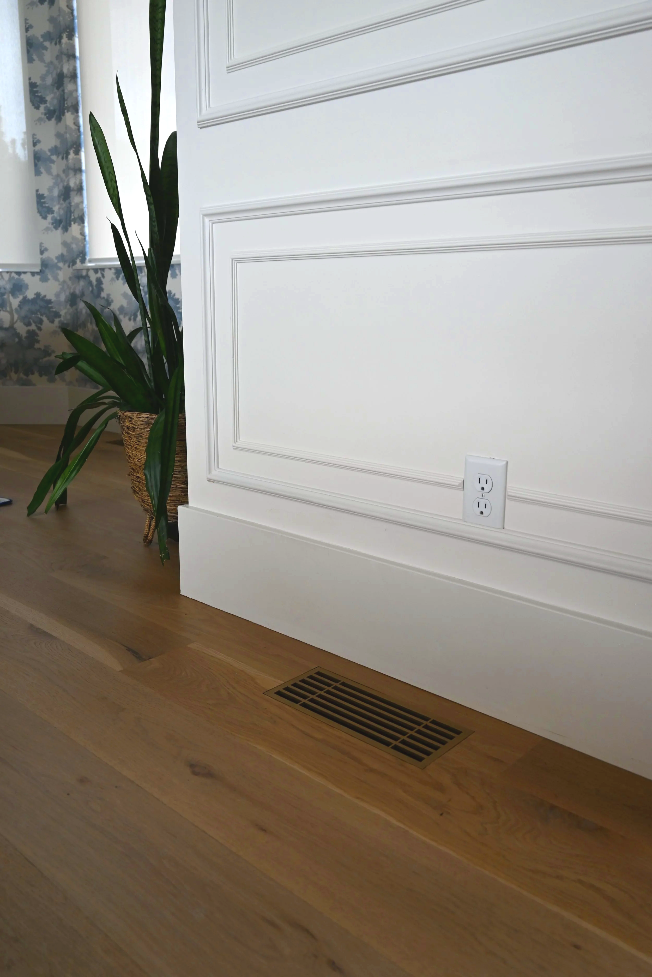 Decorative metal grate that is flush mounted in an entryway.