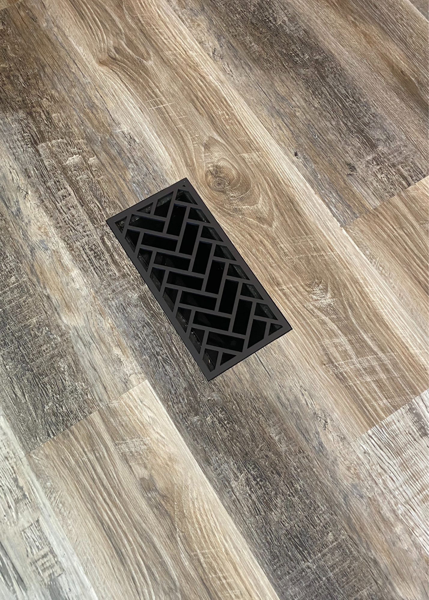 Matte bronze flush mount steel vent in the herringbone design. This metal vent has high airflow and is durable enough to be in a walking path. 