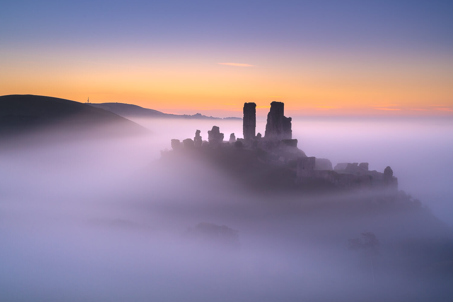 Corfe Castle above the swirling mist in Dorset