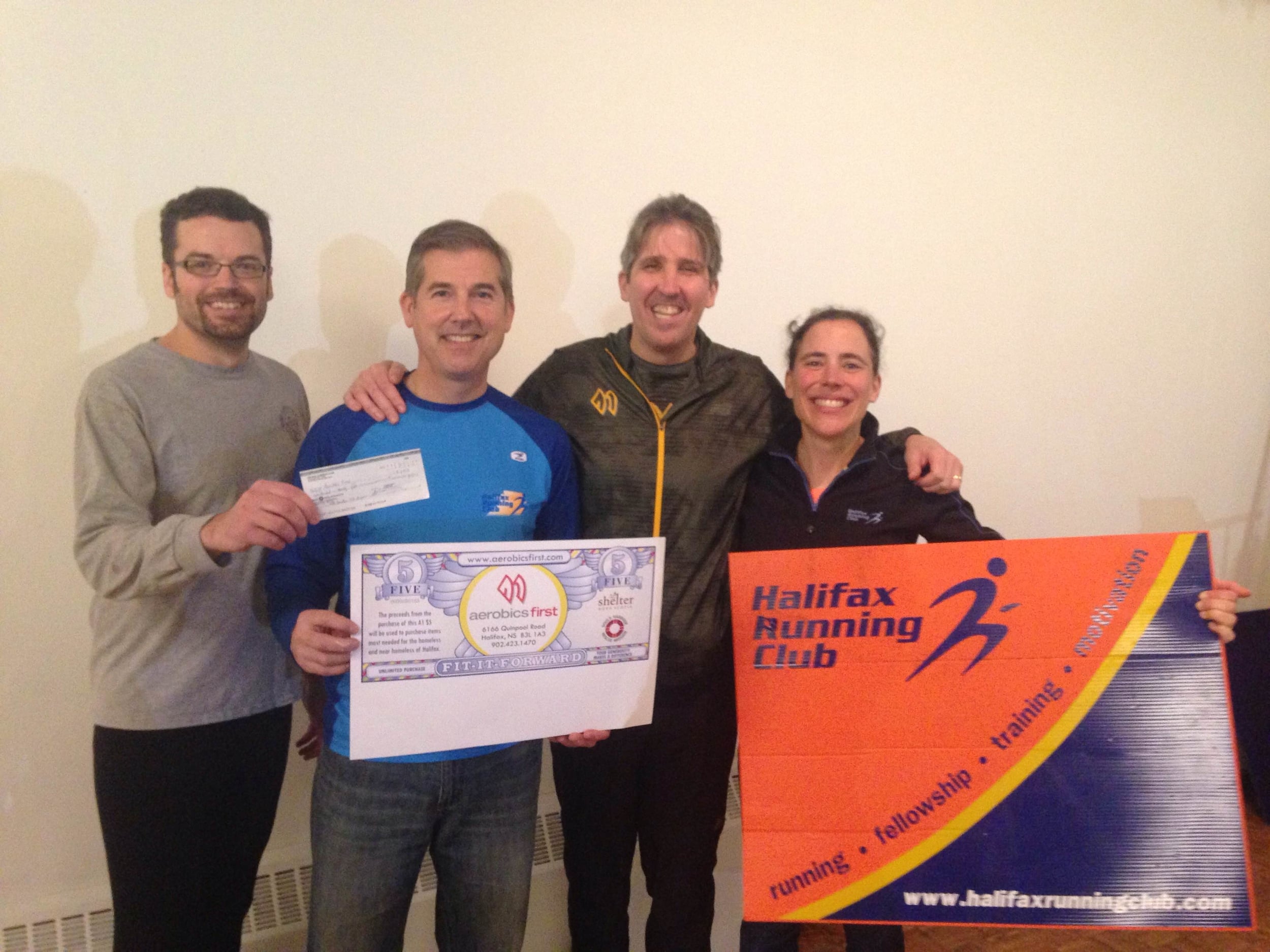 Nick McBride, Mark Pothier and Marie-Claude Gregoire present cheque to Luke MacDonald.