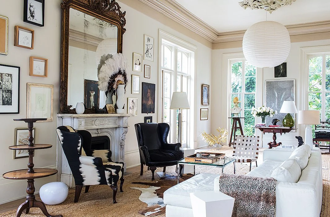 A balance of curvy and straight lines and a restrained palette unify a mix of modern pieces, Early American hand-me-downs from Sara’s parents, and two stern wing chairs.