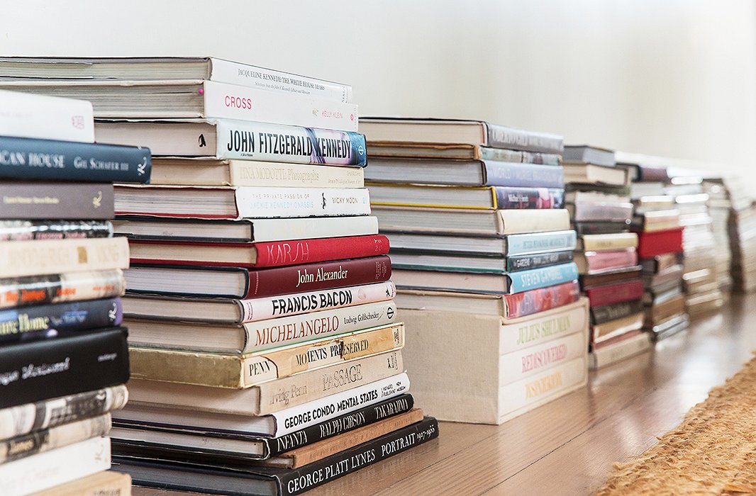 Stacked along the wall behind the couch, books are within reach and make a strong personal statement. “I love when you’re at someone’s house and you wind up poking though their bookshelves and seeing the stuff they’re reading.”