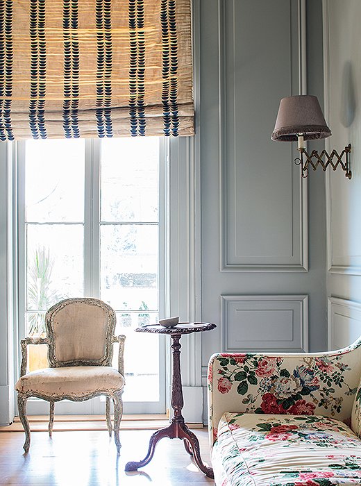 For the dining room Sara “gave a nod to New Orleans” with a pair of weathered antique French chairs, which she purposely did not reupholster. The curtain fabric is from Oscar de la Renta.