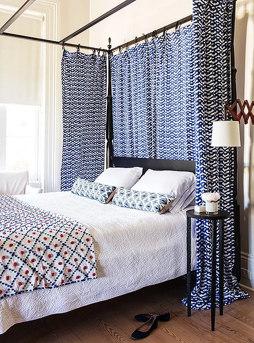 While eldest son Harrison was off at boarding school, Sara turned his room into a guest room. Roberta Roller Rabbit fabric that had previously served as kitchen curtains in New York now hang from the canopy. The colorful throw was found in a thrift store.