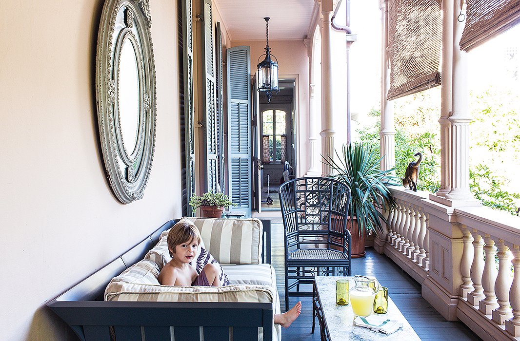 Sara spray-painted the couch and chairs on the side porch off the kitchen a charcoal gray, a subtle contrast to the floor’s blue-gray. Roll-down bamboo shades are a necessary defense against the intense New Orleans sun.