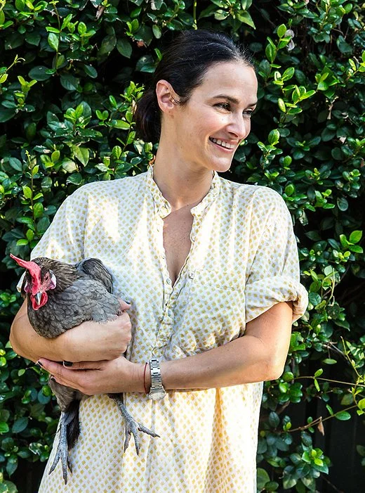 Sara with one of the family’s nine chickens, which lay the eggs the family eats and Carolina delights in selling door-to-door. “Chickens are easy if you have a coop. If you do free-range that’s a whole other story. But these are very easy.”