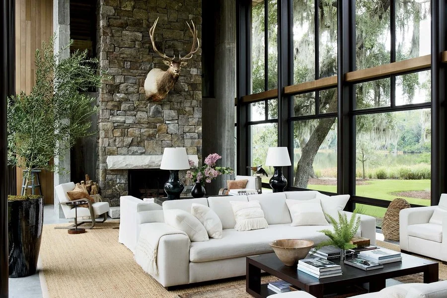 The living room includes a custom Doug Honabach coffee table and custom sofas with cushions using Dedar and Cowtan &amp; Tout; The table lamps are from Rose Tarlow, and the jute rug is from Mérida.&nbsp;Simon Upton