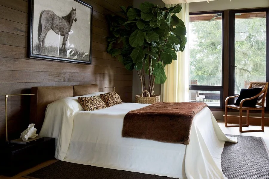 The guest bedroom features a bed and side tables from Poliform; the chair is from Henredon.&nbsp;Simon Upton