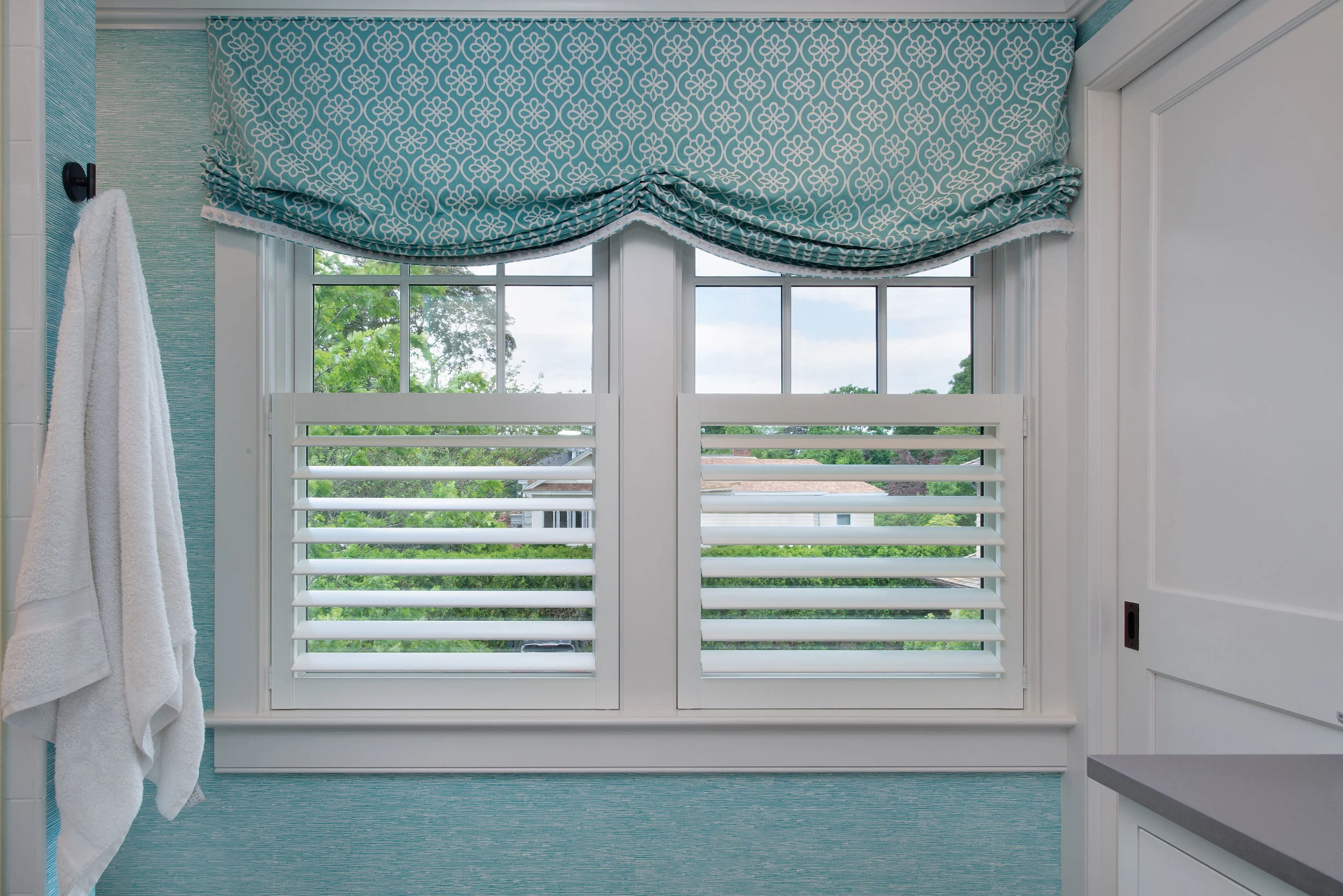 This cheery window treatment in her adjoining bathroom was a great addition to her shuttered bathroom window.