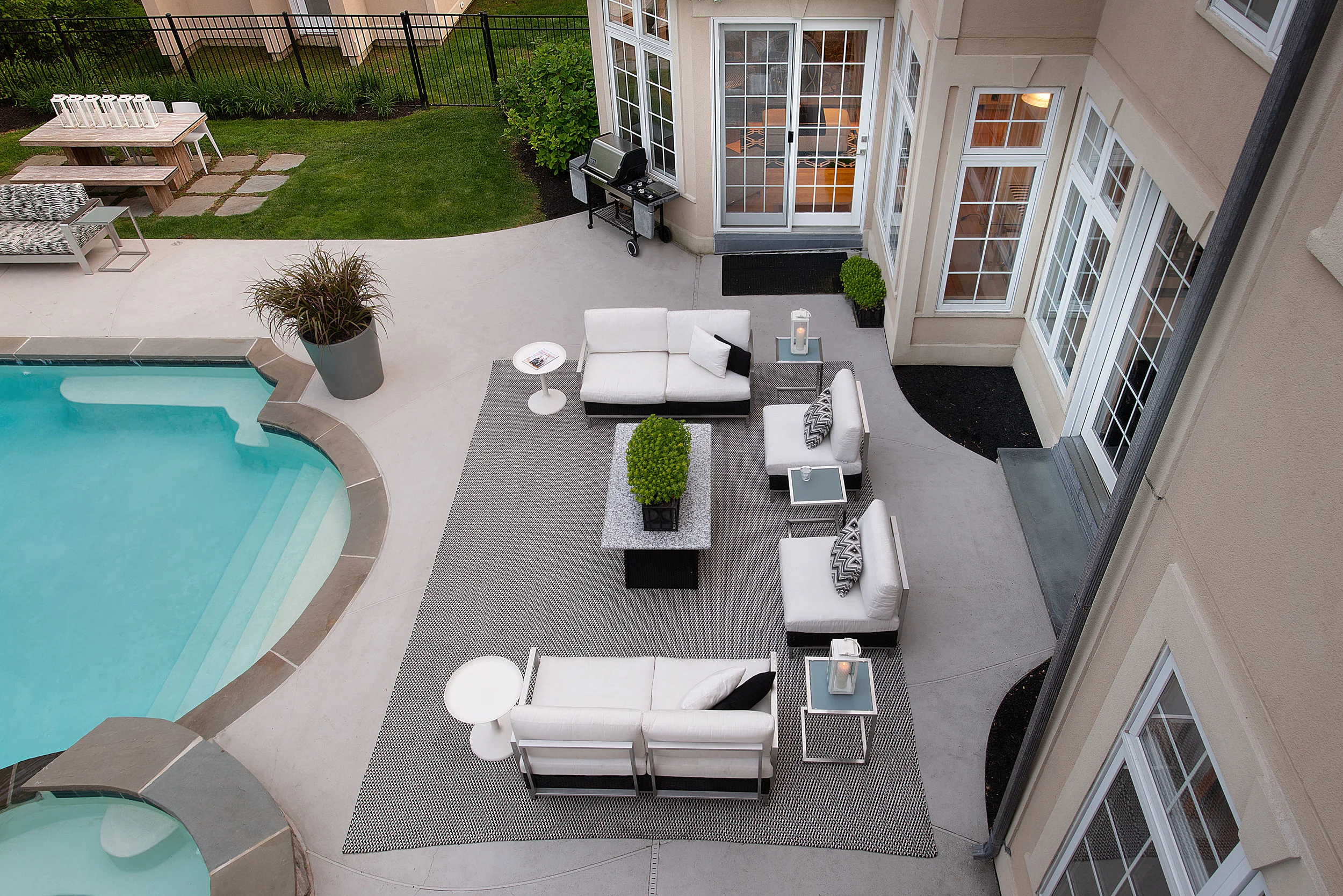 The outdoor black and white rug anchors this large gathering space.