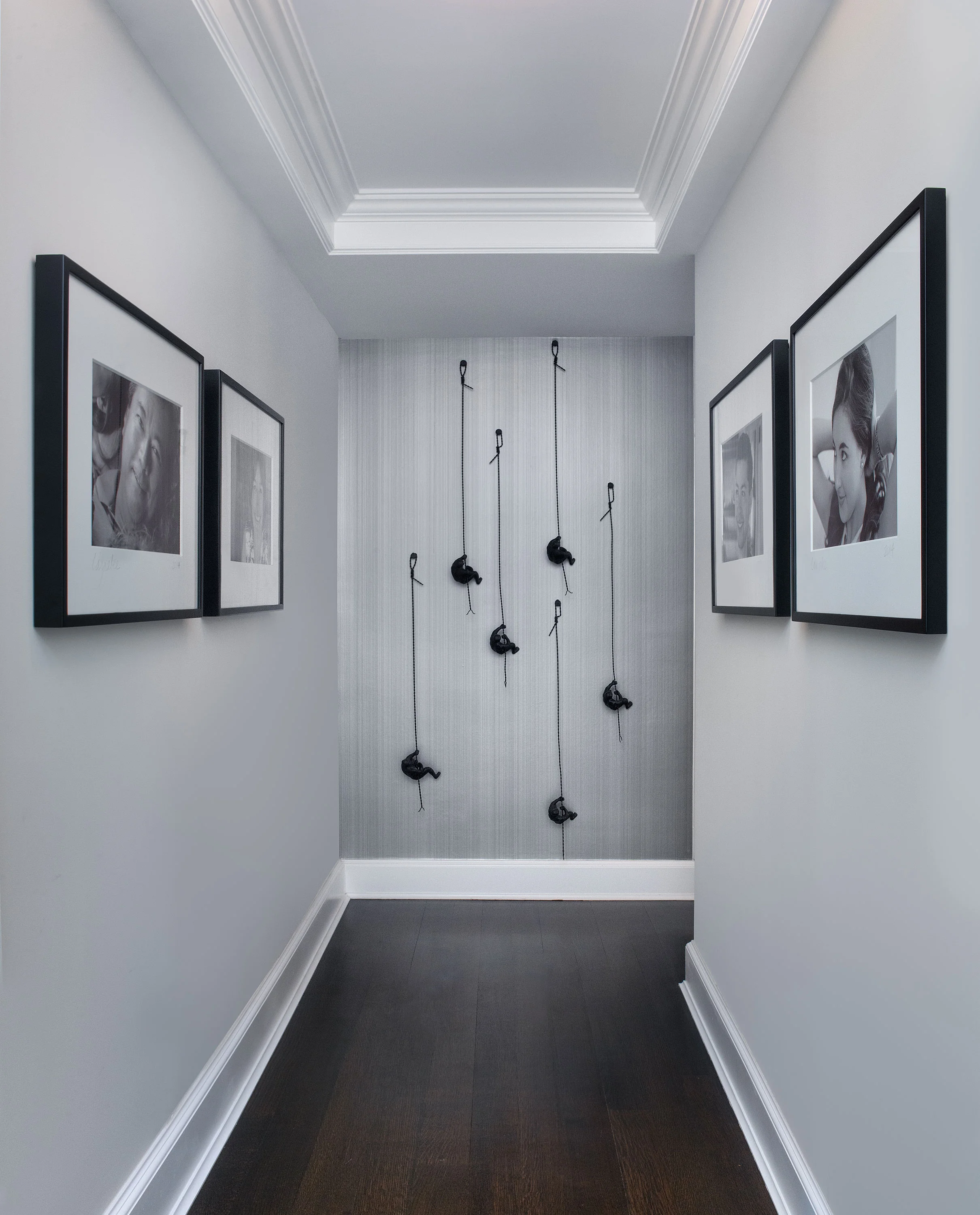 The contrast of the dark and light walls creates interest and dimension between the two hallways. The rope climbers at the end of the 2nd hallway creates an interesting focal point that draws you in. This home really came together and was great fun work on.
