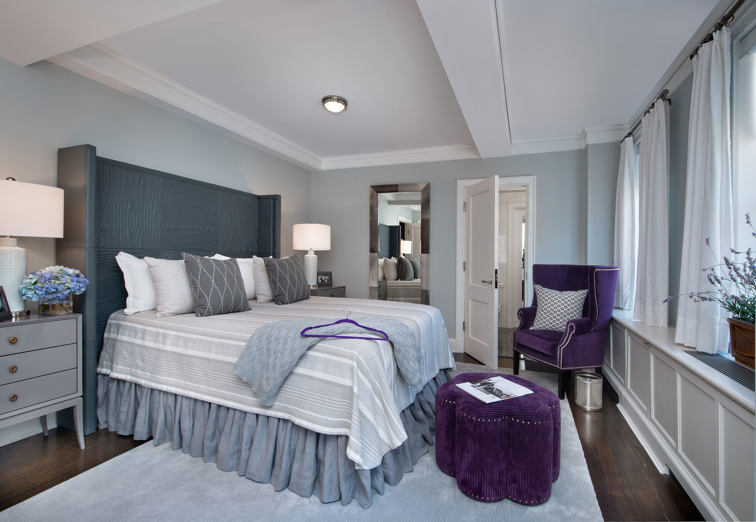 This bedroom was designed for a young adult. The plan was to be consistent with a clean contemporary feel and add pops of fun color with purple.