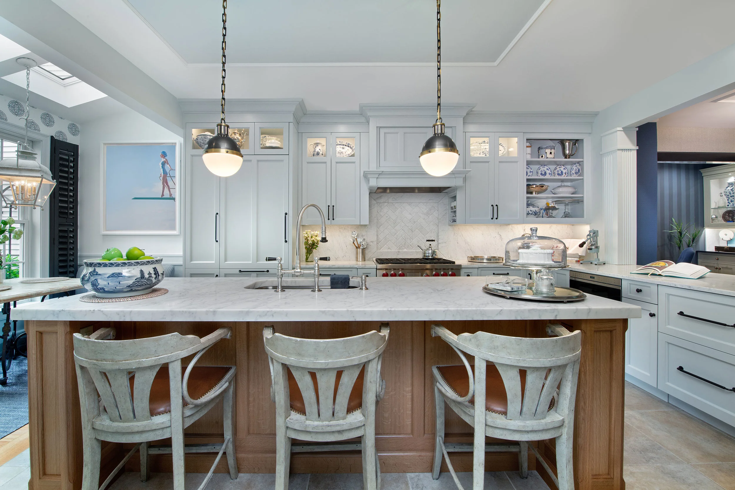 The kitchen cabinets complement the blue and white palette with a soft blue gray Farrow and Ball paint, “Borrowed Light”.