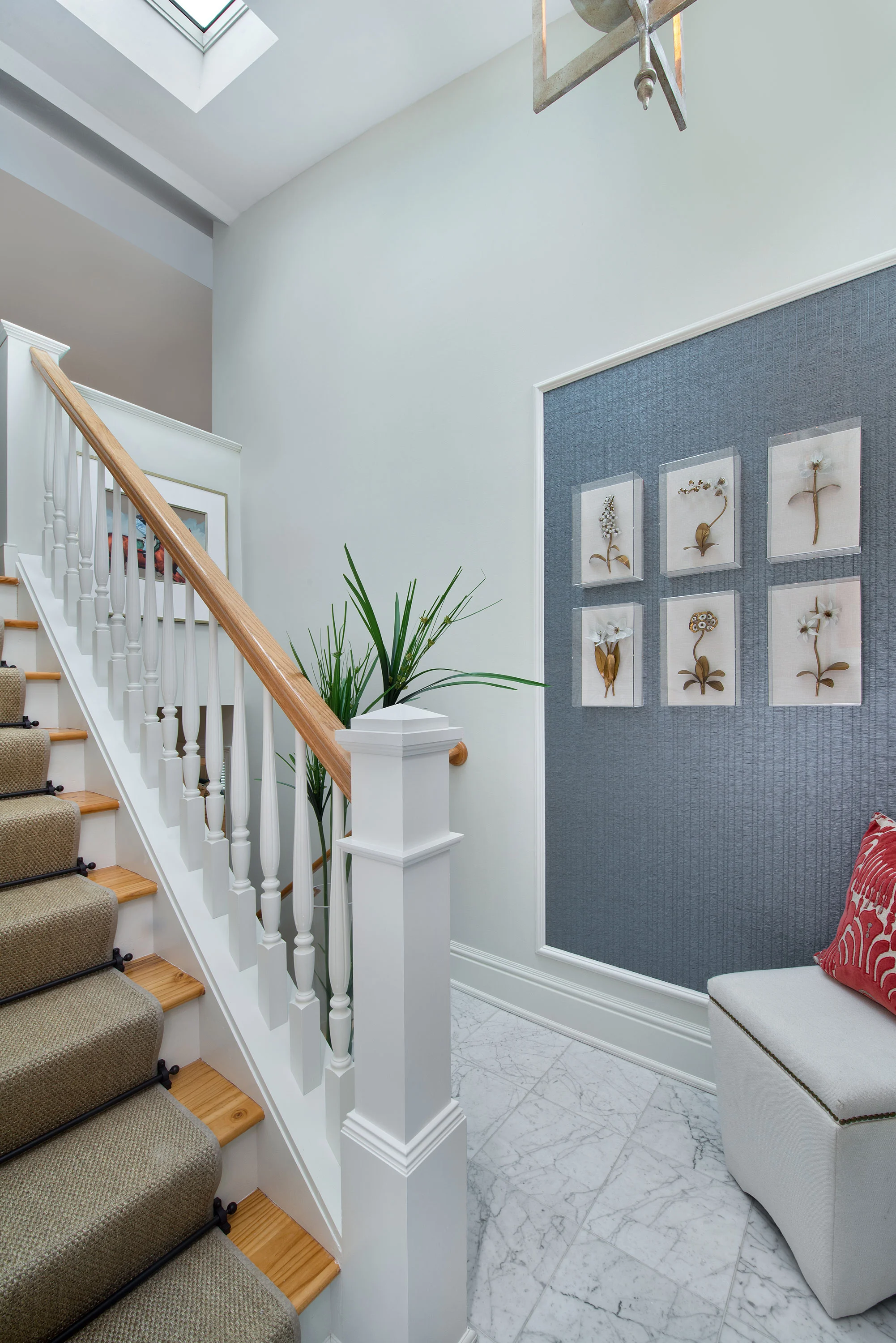 With the 3rd floor stair landing we replaced the oak flooring with white marble to break up the oak and tie in the gray/blue palette of the marble.