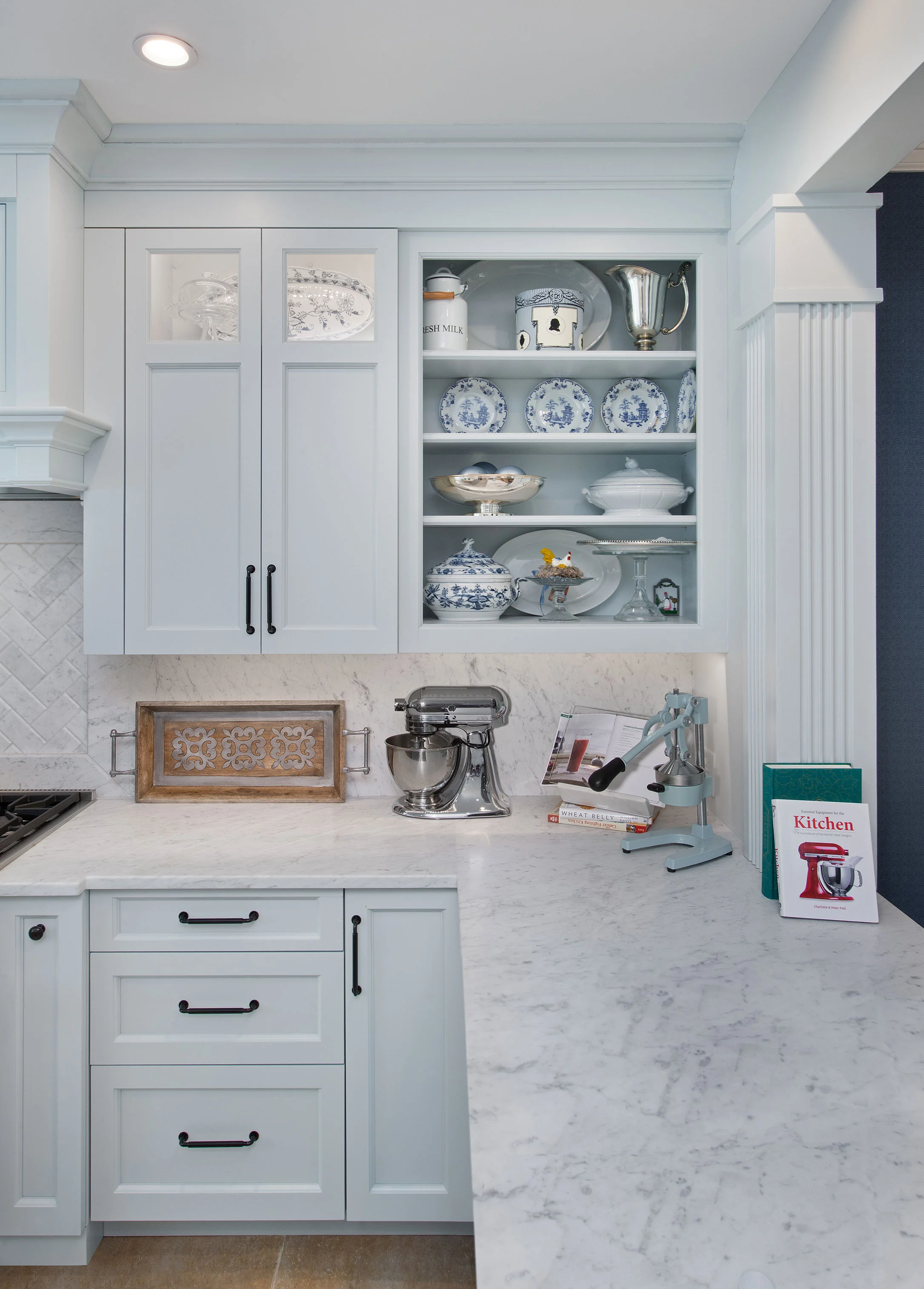 Slabs of Carrara Marble were used for the backsplash, counters and island, creating a clean look without the distraction of the tile grid.