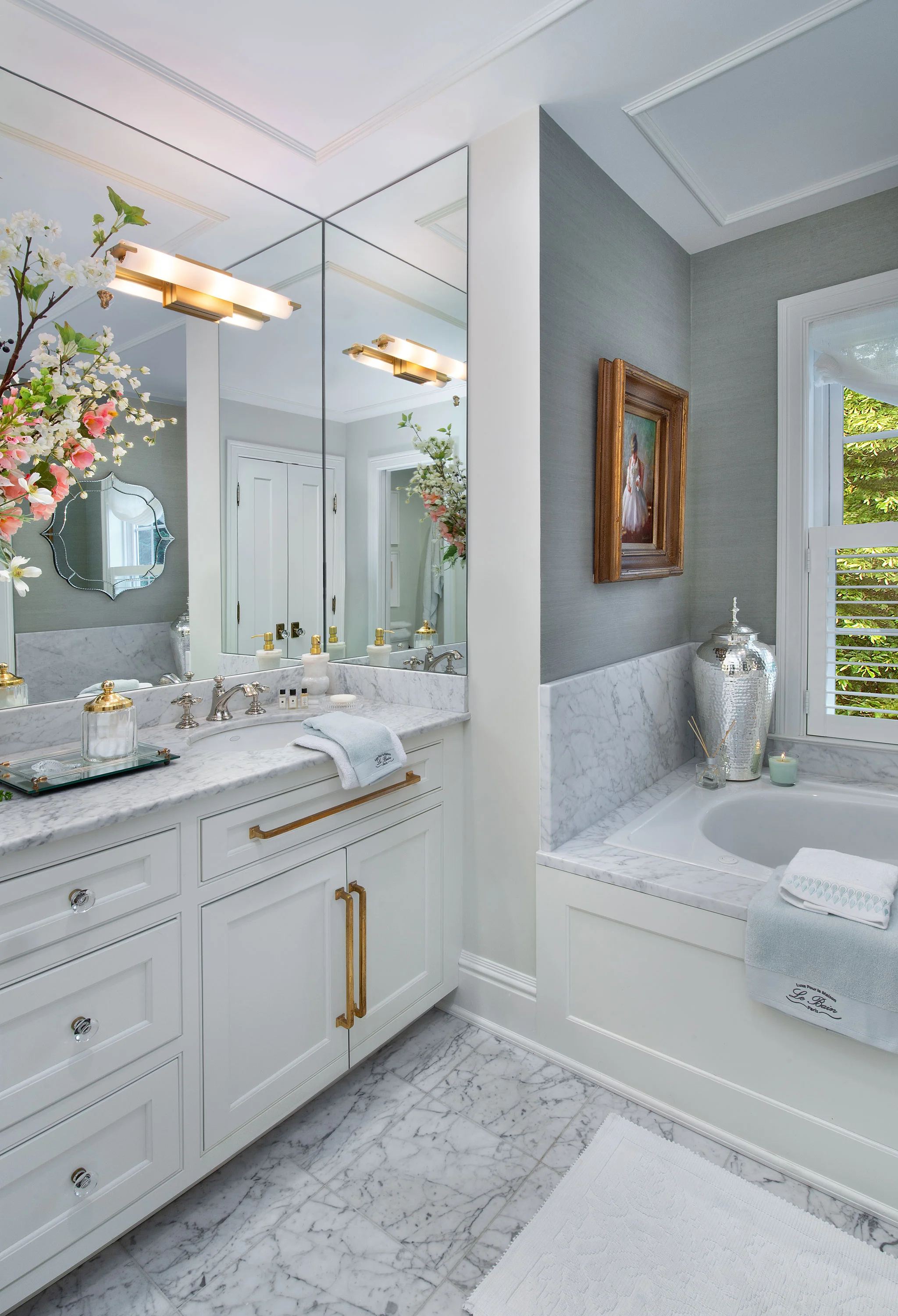 The aqua grass cloth provides a soft contrast to the carerra marble.